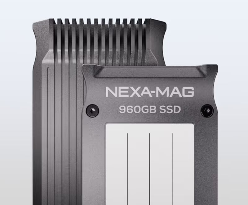 A close-up of a NEXA-MAG 960GB SSD with a metallic casing and sleek design. The drive features a ribbed top edge for improved heat dissipation and two visible screws on the faceplate.