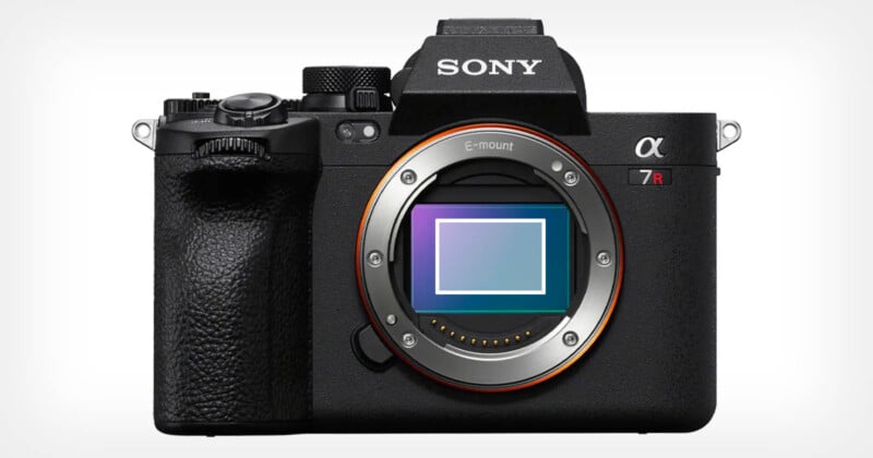 A Sony Alpha 7R camera with a visible E-mount sensor. The camera body is black with textured grip on the left side and control dials on top. The brand logo is shown on the viewfinder area in white.