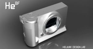 A sleek, silver camera with a modern design rests on a reflective surface. The lens is prominent, and branding for "He BF" is visible in the top left. Text at the bottom right reads "Helium Design Lab.