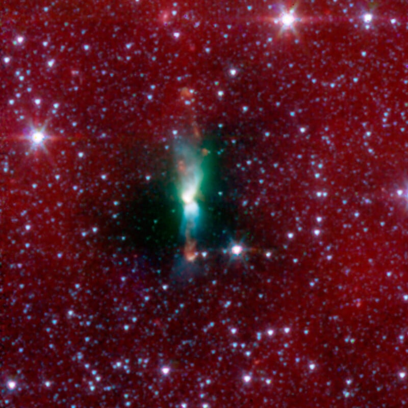 A cosmic image of Herbig-Haro 46/47 shows a bright, glowing central mass within a dark region, surrounded by a dense field of red and white stars scattered across the frame, creating a dazzling astronomical scene.