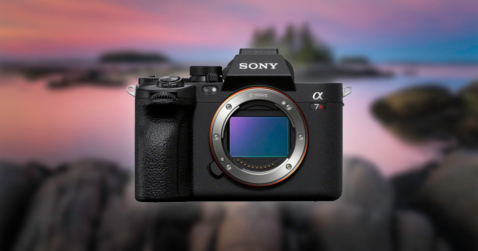 A Sony α7R IV camera with its lens removed is displayed against a blurred outdoor background. The camera is facing forward, showcasing its sensor and brand logo.