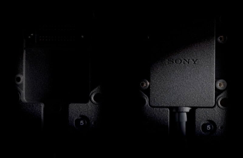 Close-up of a Sony device with wiring attached, partially illuminated in low lighting. The device is black, with visible screws and a small number "5" near the bottom.