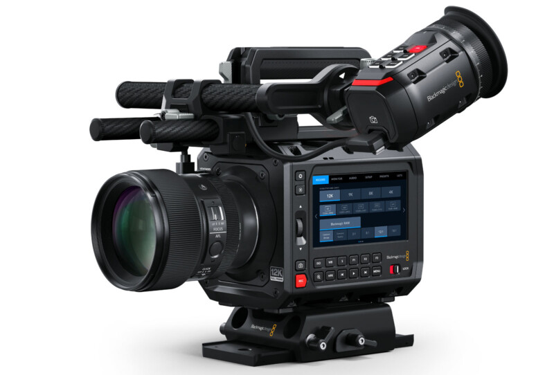 Professional cinema camera with a lens and a digital viewfinder attached, featuring multiple buttons and a touchscreen display for settings. The camera body is equipped for high-resolution video recording.