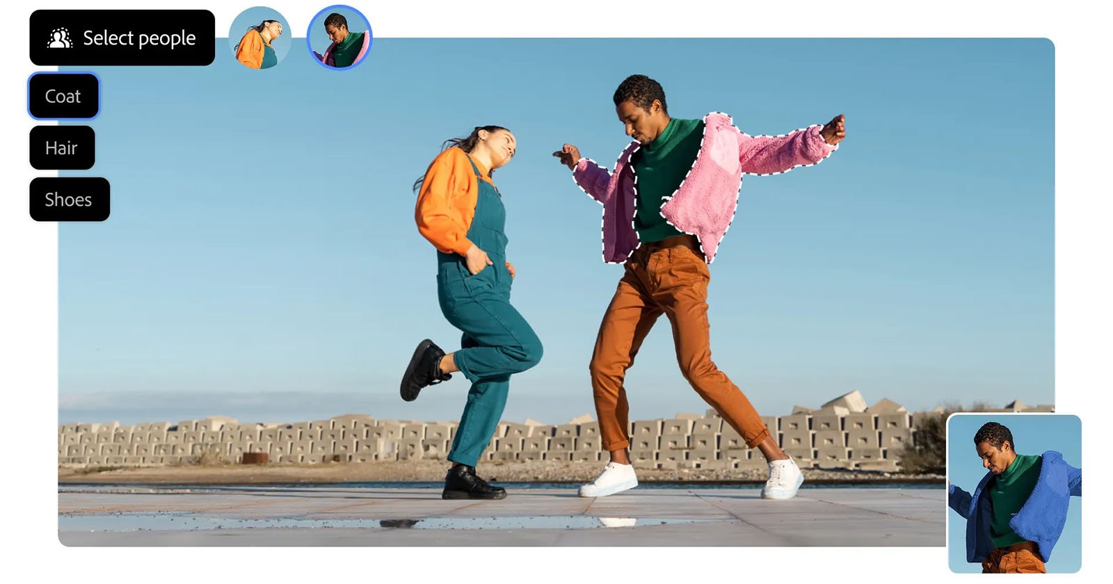 Two people dance energetically outdoors on a paved surface under a clear blue sky. Both wear colorful outfits; one in an orange shirt and teal pants, the other in a pink jacket and brown pants.