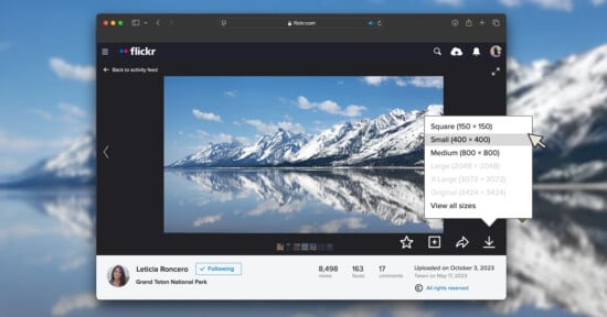 A computer screen displays a Flickr photo of snow-capped mountains reflected in a lake, with a menu open showing image size options like small, medium, and original.