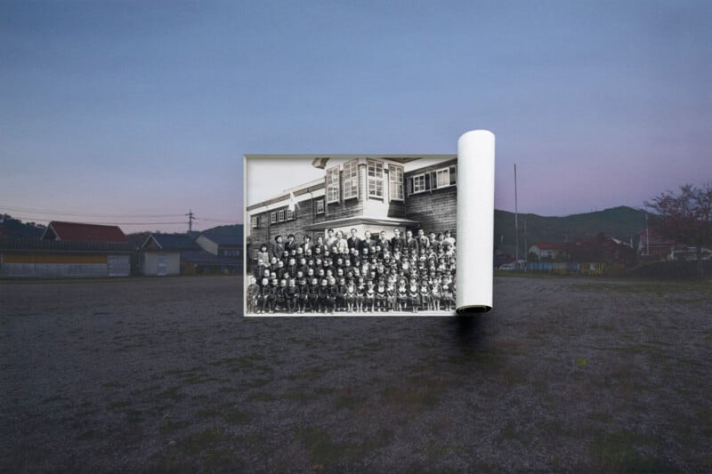 A large black-and-white photo of a group of people in front of a building appears as if unrolled in the middle of an empty outdoor field at dusk, blending past and present scenes.