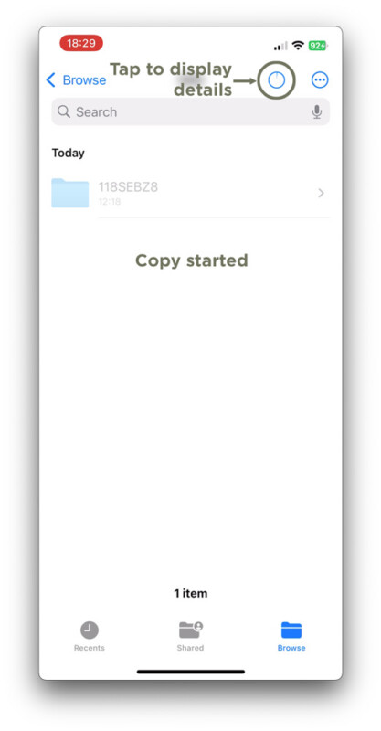 A screenshot of the iPhone Files app showing a folder named "118SEBZ8" and the message "Copy started." An arrow points to the info icon at the top, labeled "Tap to display details.