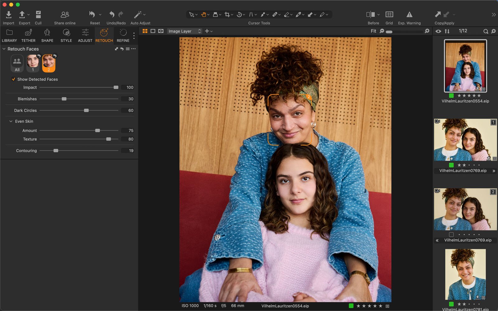 A smiling woman with curly hair and a blue jacket hugs a girl in a pink sweater from behind, posing together in a photo editing software interface with image adjustment sliders visible on the left.