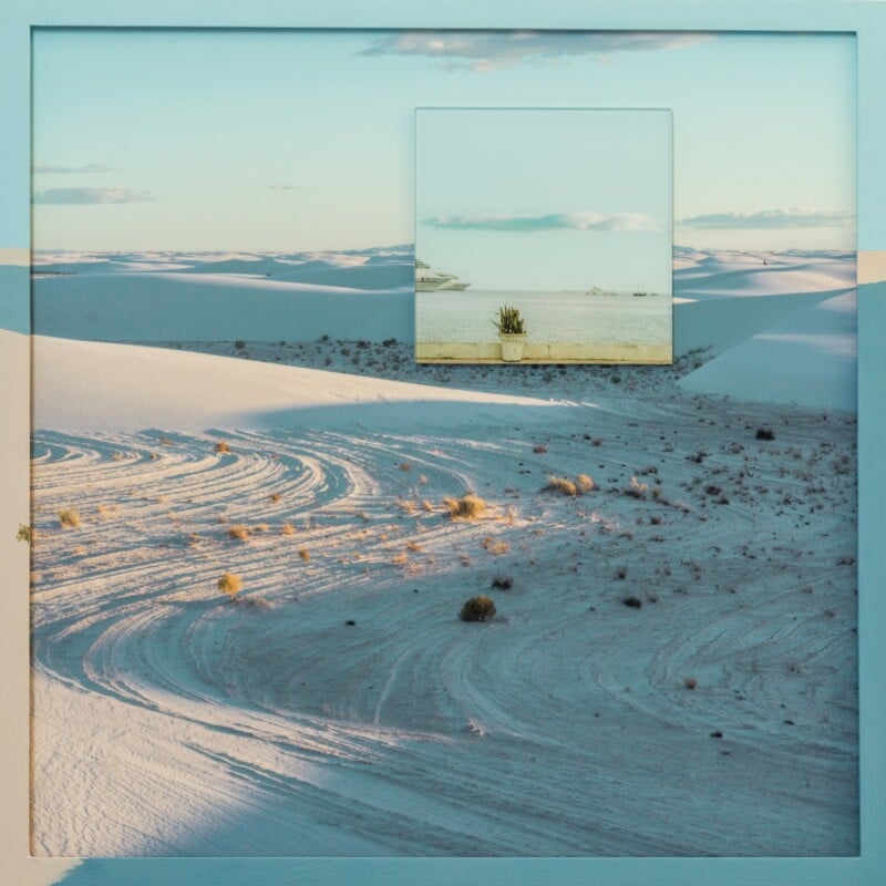 A framed photo of a desert landscape with white sand dunes and sparse vegetation. In the center, a smaller photo shows a potted cactus on a ledge, blending with the sandy backdrop.