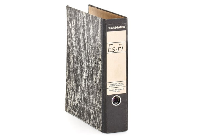 A black and gray marbled lever-arch file folder with a beige label on the spine, featuring the text “SEGREGATOR” and “Es-Fi,” standing upright on a white background.