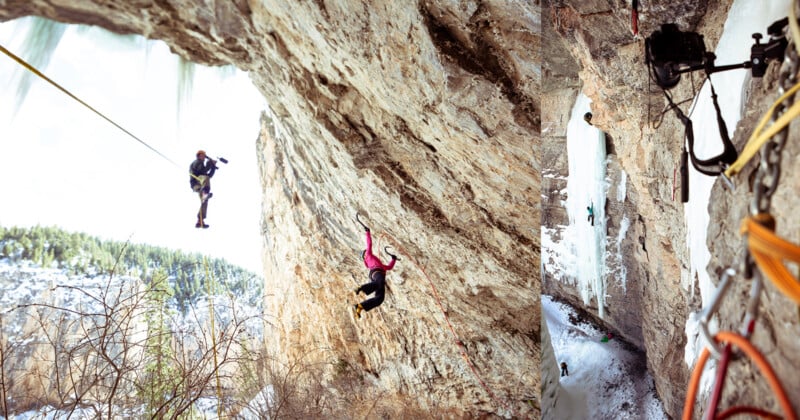 Two rock climbers hang from ropes on a steep, rocky cliff with snowy trees below. On the right, climbing gear and a camera are attached to the rock wall above icy terrain.