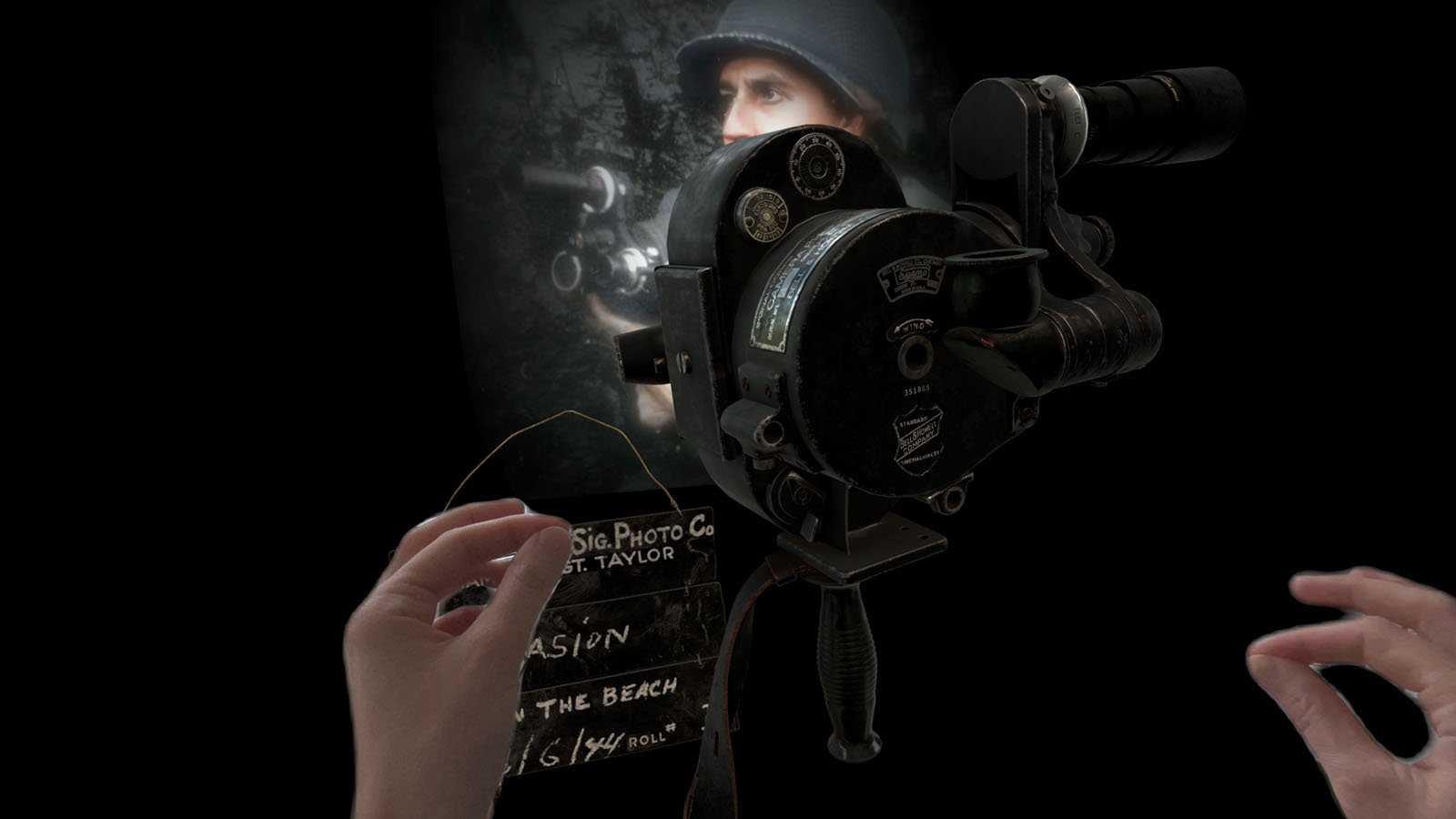 A pair of hands operates a vintage film camera, filming a person in a helmet visible on the camera’s screen, with a slate reading “On the Beach” and other details in the foreground.