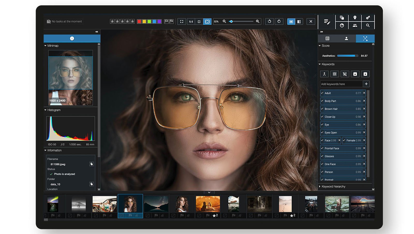 A computer screen displays a photo editing software with a close-up portrait of a woman wearing large sunglasses. Editing tools, sliders, and adjustment panels are visible around the main image.