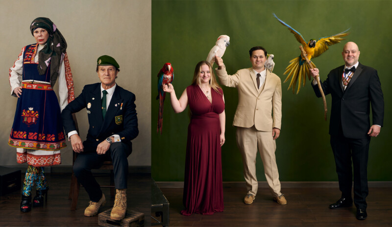 A group of five people pose indoors against a green wall: two in traditional and military attire on the left, and three in formal outfits on the right, each holding or interacting with colorful parrots and a white cockatoo.