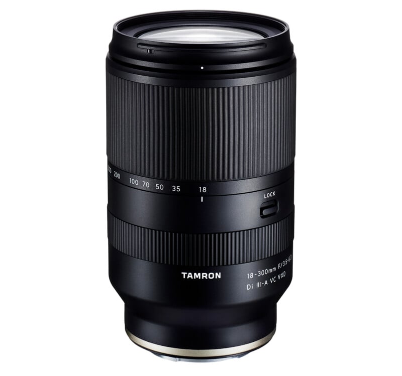 A black Tamron camera lens with zoom and focus rings, labeled "18-300mm F/3.5-6.3 Di III-A VC VXD," standing vertically against a white background.