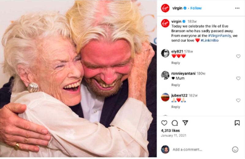 An elderly woman and a man with blond hair and a beard hug each other and laugh joyfully. The Instagram post honors the life of Eve Branson, expressing love and condolences from the Virgin family.