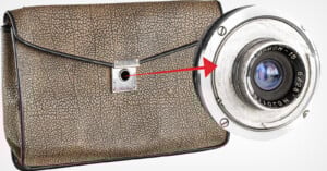 A vintage, textured brown handbag with a hidden camera lens revealed behind a flap, highlighted by a red arrow pointing from the bag’s clasp to the close-up of the camera lens.