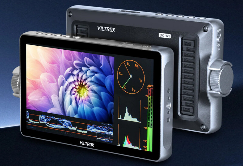 Two Viltrox DC-A1 camera monitors are shown; one displays a colorful flower image with histograms and graphs, while the other shows the back with control dials and buttons. Both are silver with black screens.