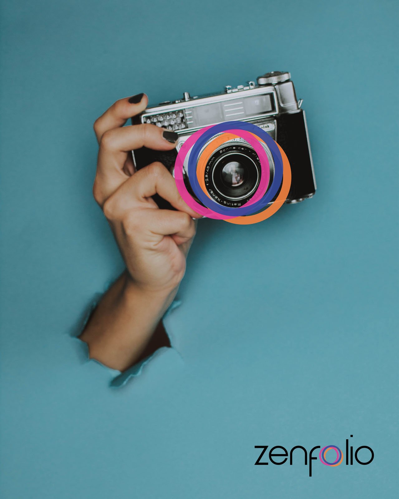 A hand holding a vintage camera emerges through a torn blue paper background. The camera lens is decorated with colorful rings. The word "zenfolio" appears in the lower right corner.