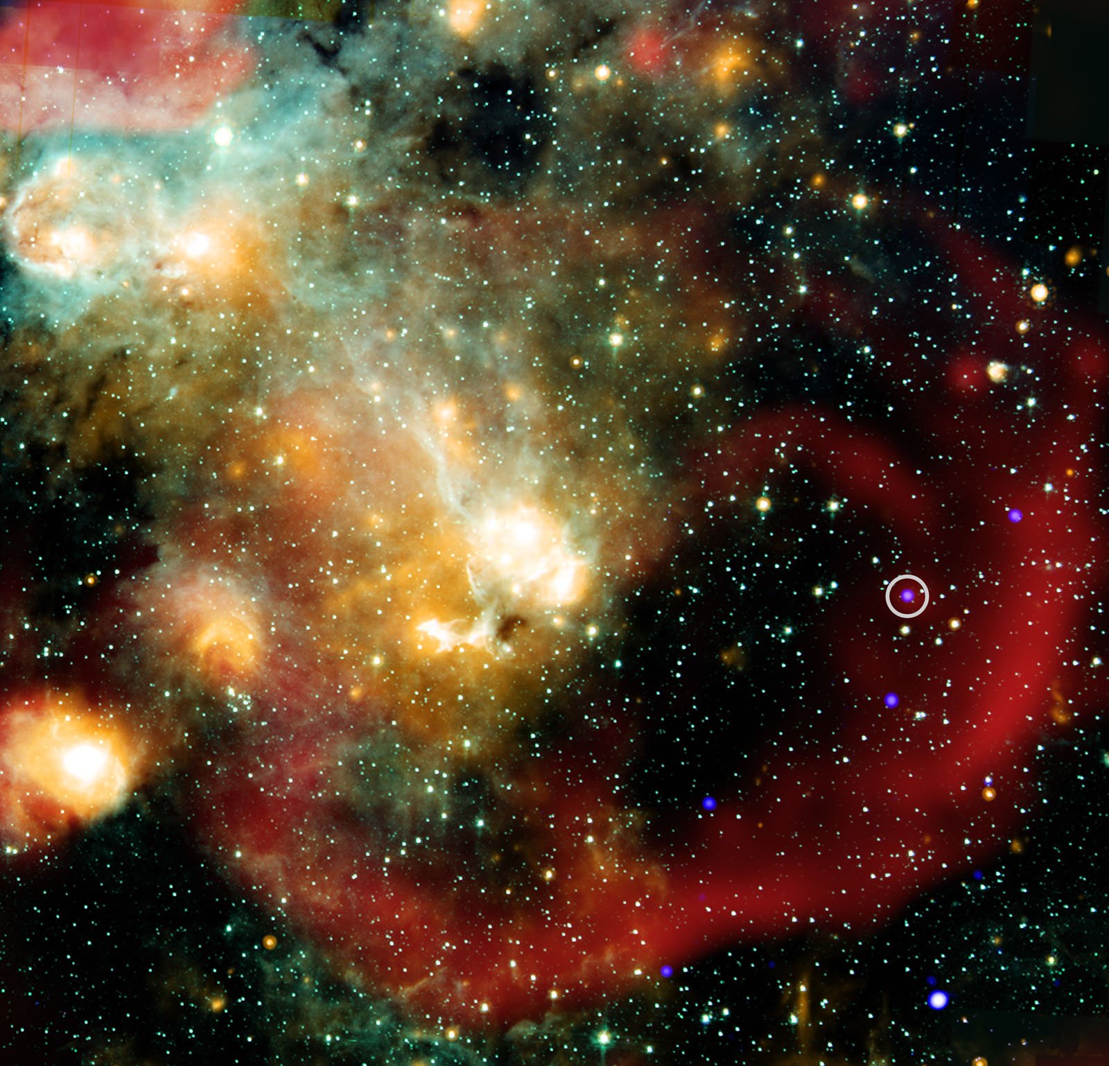 A colorful space scene showing a dense star field, glowing clouds of gas in orange, yellow, blue and green hues, and a prominent red arc, with a small white circle highlighting a spot on the right side.
