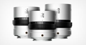 Three silver camera lenses labeled 45, 32, and 65 are displayed upright against a white background. Each lens has a black gear ring and engraved aperture markings.