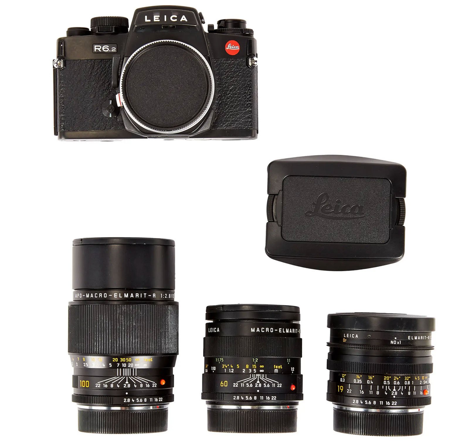 A Leica R6.2 film camera body with a lens cap, three interchangeable Leica lenses of different focal lengths, and a black camera case arranged on a white background.