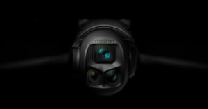 Close-up of a Hasselblad camera with three lenses, set against a dark background, highlighting the camera's sleek and modern design.
