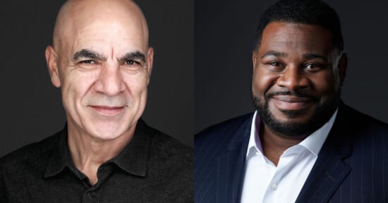 Two men in professional headshots against dark backgrounds. The man on the left is bald, light-skinned, and wears a dark shirt. The man on the right has short black hair, dark skin, a beard, and wears a pinstripe suit with a white shirt.