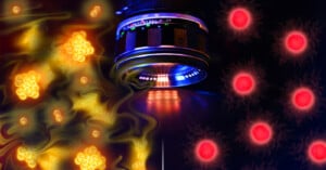 A camera lens is centered between a glowing yellow abstract pattern on the left and bright red circular lights on the right, creating a contrast between warm and cool tones in a science-inspired composition.