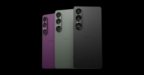 Three Sony Xperia smartphones are shown standing upright in purple, green, and black colors, with the camera lenses visible on the left side of each phone’s back against a black background.