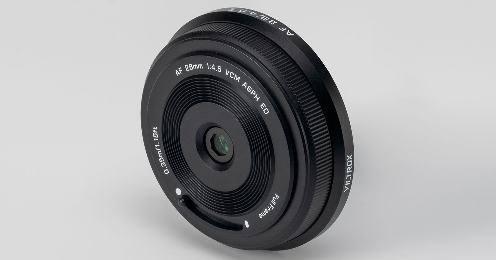 A close-up photo of a Viltrox AF 28mm f/1.4 camera lens, shown at an angle on a plain white background. The lens details and branding are clearly visible on the black barrel.