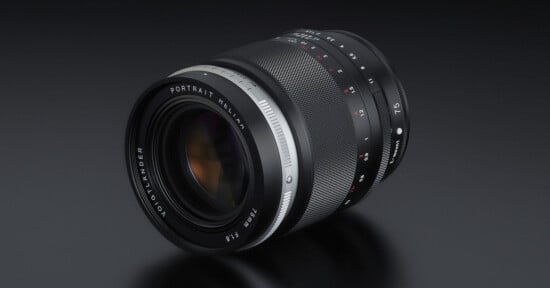 A close-up view of a Voigtländer camera lens with "PORTRAIT HELIAR 75mm F1.8" and various aperture settings visible, set against a dark, reflective background.