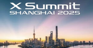 Skyline of Shanghai at sunrise with tall skyscrapers and the text 'X Summit Shanghai 2025' displayed above.