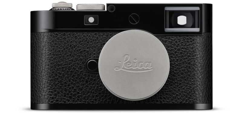 A black Leica rangefinder camera with a textured grip and a silver lens cap bearing the Leica logo, shown from the front against a white background.