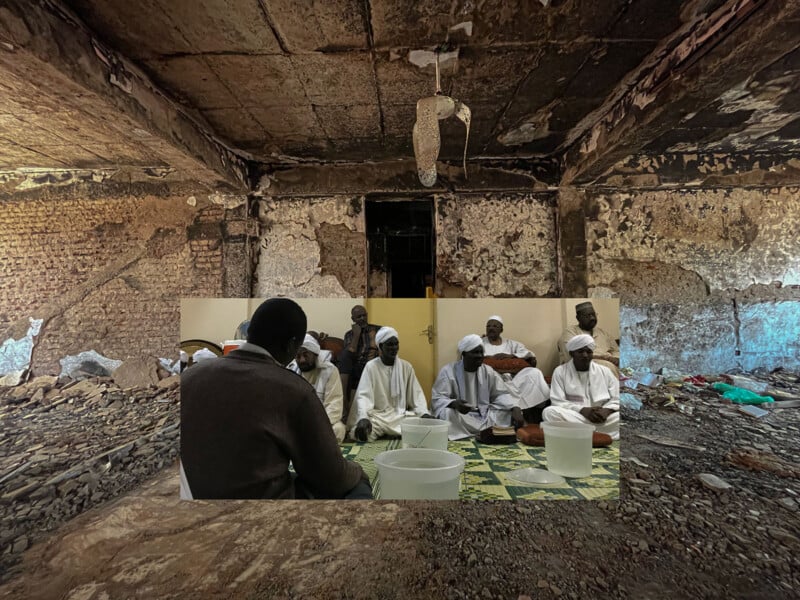 A group of men in white robes sit in a circle on a green mat indoors, superimposed over a background of a burned, dilapidated room with charred walls and debris on the floor.