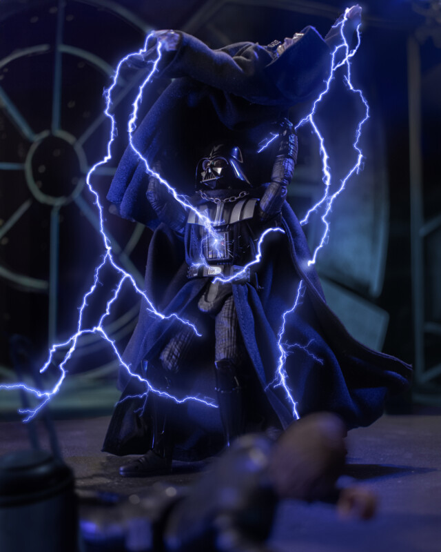 Darth Vader lifts Emperor Palpatine above his head amid crackling blue lightning inside the Death Star, with another figure lying on the floor in the foreground.