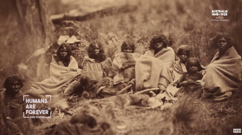 A sepia-toned historical photograph shows a group of Aboriginal people, including women and children, sitting on the ground wrapped in blankets, with a background of grass and trees. Text overlays read "Humans Are Forever," and "Australia 1848–1925.