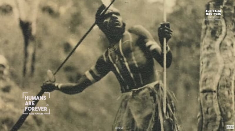 A black-and-white photo of an Indigenous Australian man holding a spear and a spear thrower, with body paint on his chest and arms. The background is blurred, and text reads “Humans Are Forever” and “Australia 1848–1925.”.