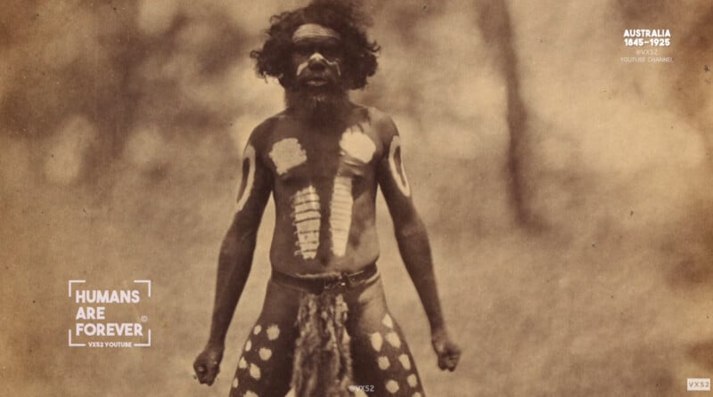 A historical photo of an Aboriginal Australian man with traditional body paint, wearing a decorated garment, standing outdoors. The image has a sepia tone and text overlay that reads “HUMANS ARE FOREVER” and “AUSTRALIA 1848–1925.”.