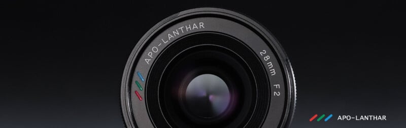 Close-up of a camera lens labeled "APO-LANTHAR 28mm F2" against a dark background, with the APO-LANTHAR logo and name in the bottom right corner.