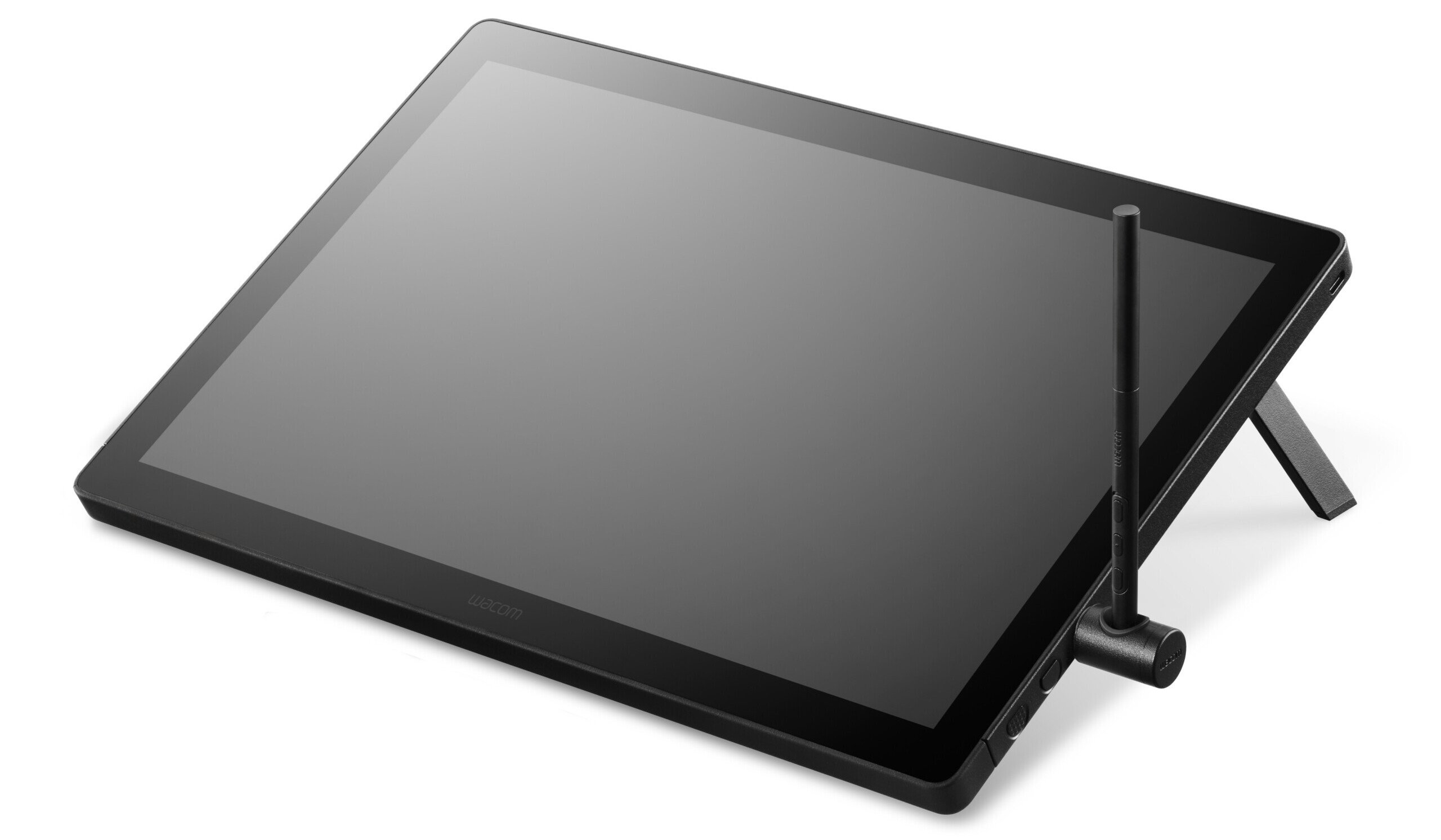 A digital drawing tablet with a large display screen, angled on a stand, with a stylus pen resting upright in its holder beside it.