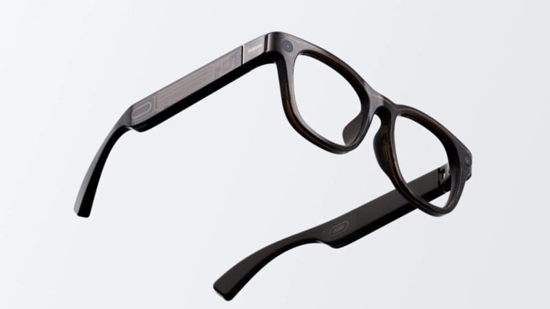A pair of black rectangular eyeglasses with thick frames and arms, shown floating against a plain light gray background.