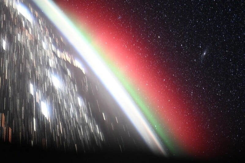 A view from space of Earth’s curved horizon, glowing with red and green auroras against a backdrop of bright stars and galaxies in the dark sky.
