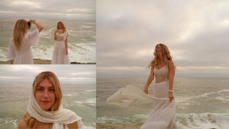 A woman in a white dress on a beach.