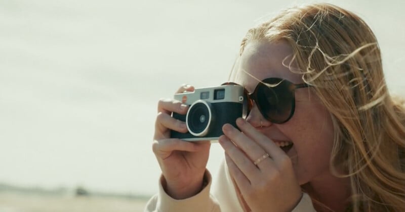 A woman holding a camera.