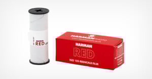 A Harman RED ISO 125 redscale film roll stands beside its red and white box labeled "Harman Photo RED, ISO 125 Redscale Film" on a plain white background.