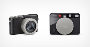 Two compact Leica digital cameras, one shown angled to display its lens and textured grip, and the other facing forward with a large silver lens cap covering the lens, both on a plain white background.