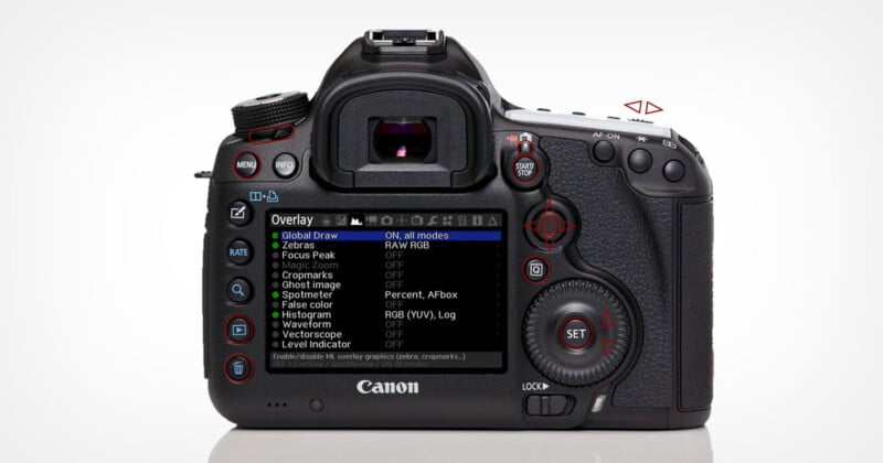 A Canon DSLR camera viewed from the back, displaying an on-screen settings menu labeled "Overlay" with various options such as Zebras, Focus Peak, and Histogram. Several buttons and dials are visible around the screen.