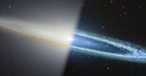 A galaxy seen edge-on with a bright core divided by a diagonal line; the left side is hazy and smooth, while the right side is detailed with blue spiral arms and stars.