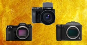 Three black medium format digital cameras—Fujifilm, Phase One, and Hasselblad—are displayed against a textured gold background.